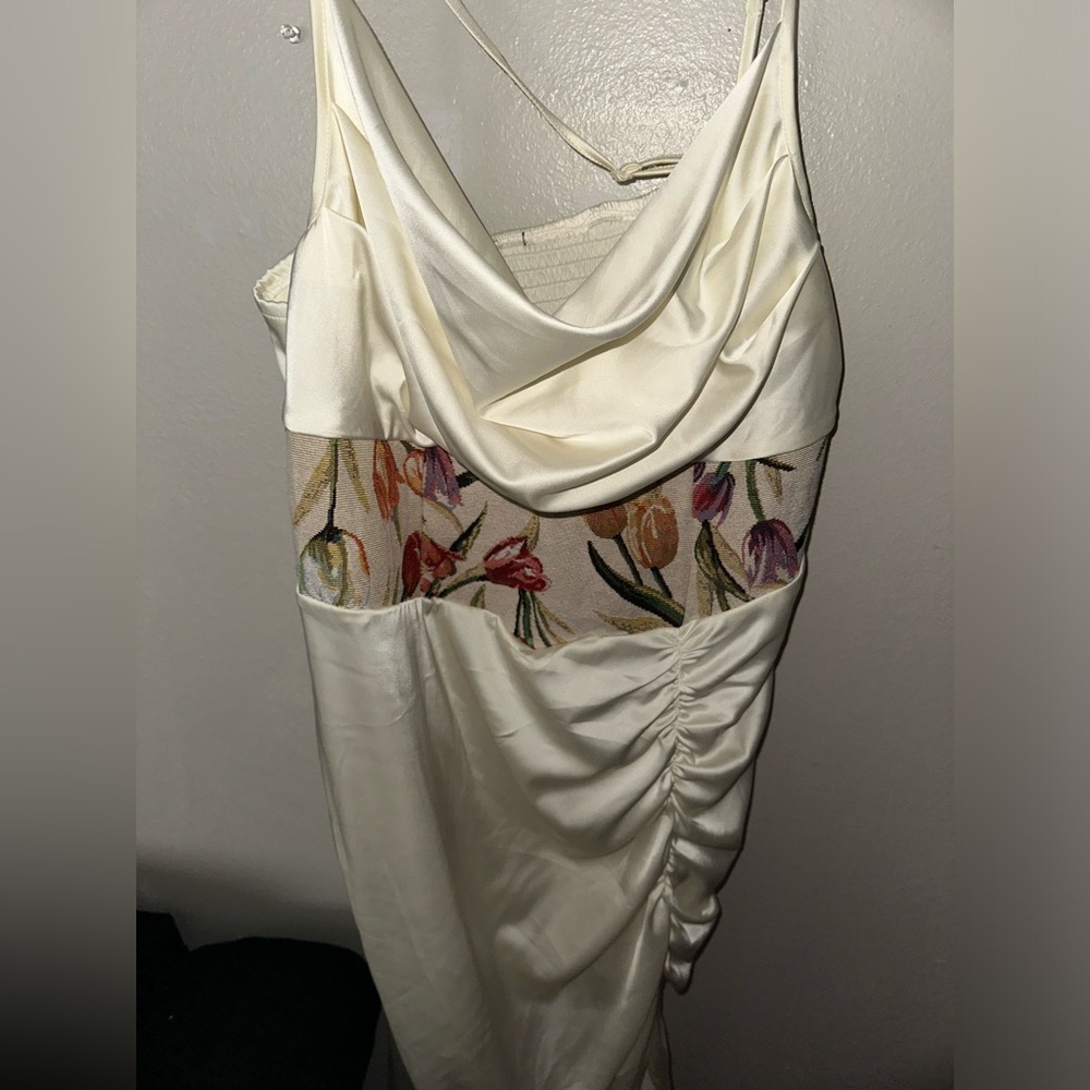 crème colored dress that has never been worn with a zipper on right side.